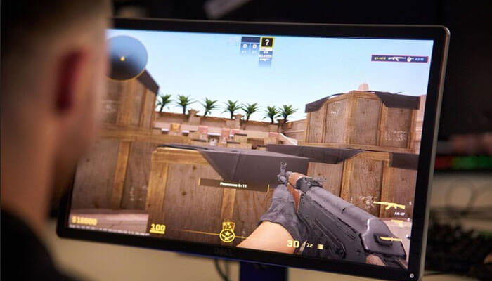 Gamer plays first-person shooter on a tactical desert map, focusing on aiming to avoid common valorant pitfalls.