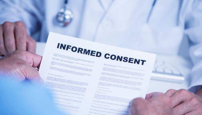 Doctor presenting informed consent to a patient, for the latter to make an informed decision for safer medical care.