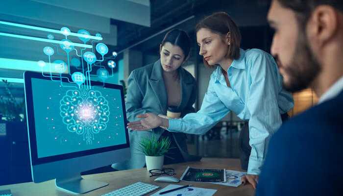 Business team exploring edge ai solutions on a computer screen, illustrating the power of artificial intelligence in decision-making.