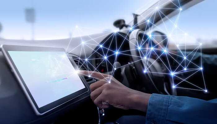 Close-up of a driver interacting with a smart touchscreen inside a vehicle, showcasing advanced technology and connectivity features that enhance automotive performance.
