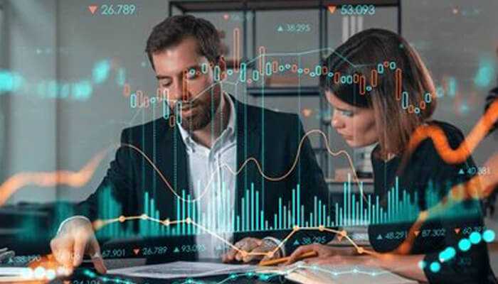 Business professionals analyzing data and trends to manage energy market volatility, utilizing technology and insights to navigate price fluctuations.