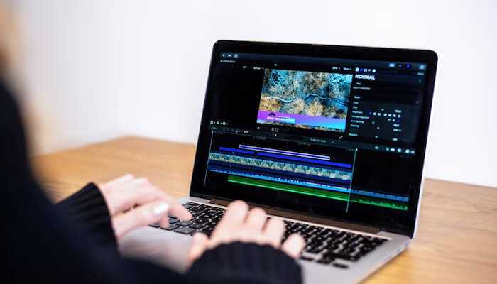 A person editing a video timeline on a laptop, showcasing professional video watermarking techniques to preserve content integrity and prevent unauthorized use.