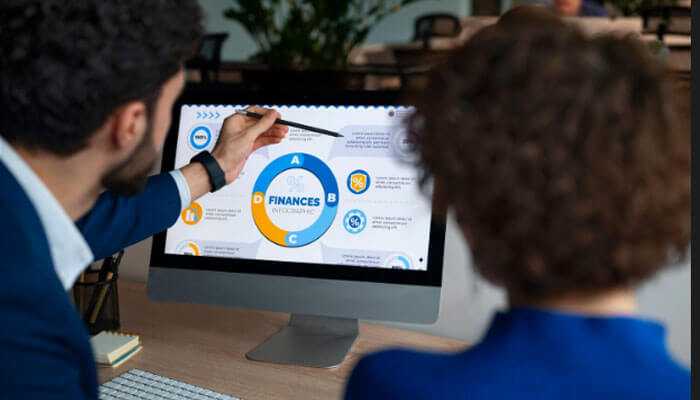 Team reviewing r&d metrics on a desktop screen, evaluating financial performance and innovation indicators for research and development decisions.