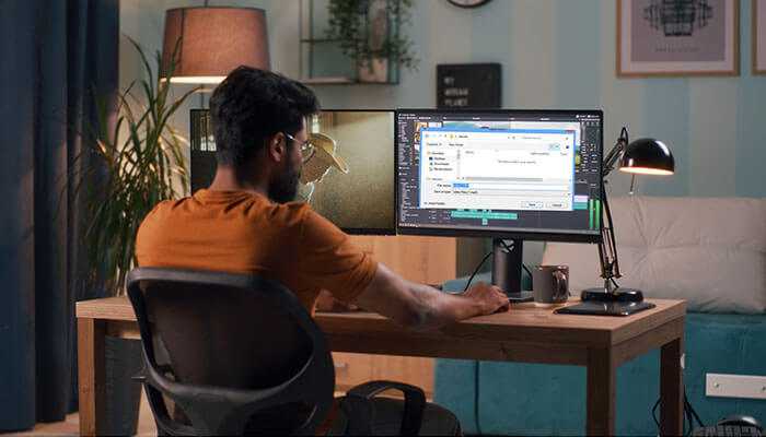 Woman working on a computer showing how to screen record on windows for tutorials or presentations.
