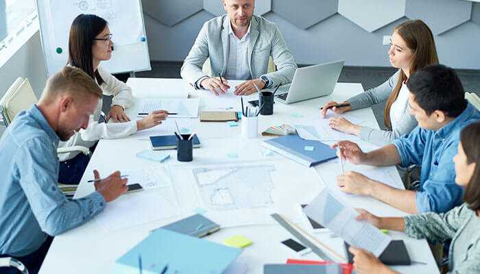 Corporate team discussing financial recovery strategies after a company voluntary arrangement, focusing on rebuilding and future planning.