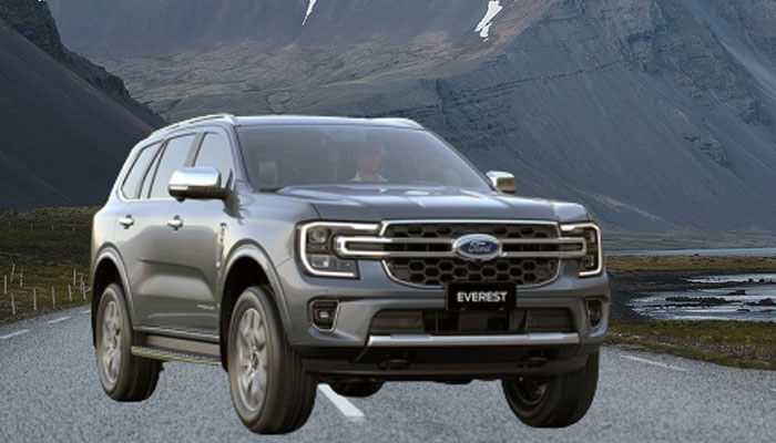 Grey ford everest suv driving on a scenic mountain road.