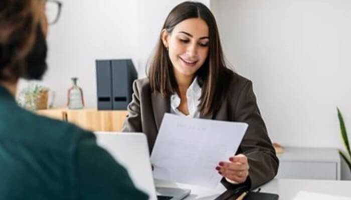 Hr manager reviewing a candidate's resume during an interview as part of the Mental Ability Test hiring process.