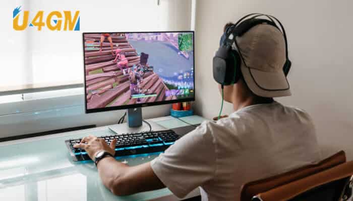 Gamer playing monopoly go on a desktop computer using headphones and keyboard at a home setup