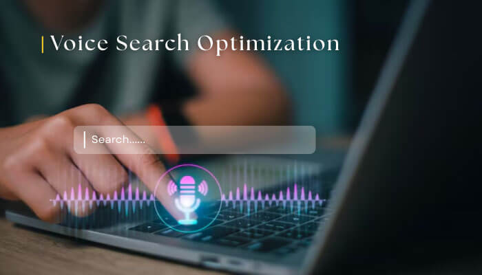 Image showing a person using a laptop with a voice search optimization interface. The screen displays a search bar with a voice input icon and soundwave visualization, highlighting the growing role of voice search in digital marketing and the legitimacy of voice search optimization in 2026.