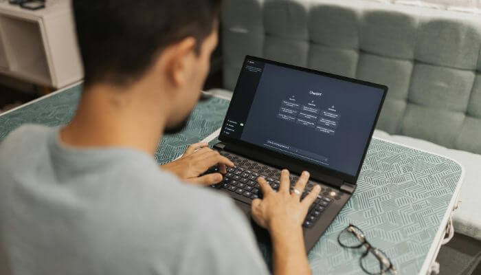 AI Writing Tools Updates 2026 showing a content creator using an AI writing platform on a laptop for content generation, SEO optimization, and workflow automation.