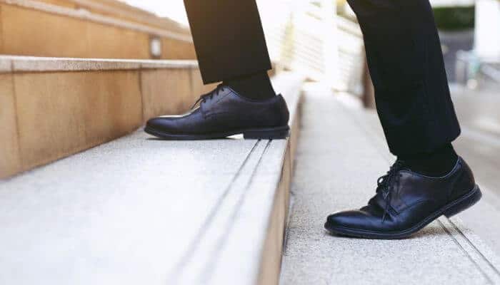How to complete the first step in the decision-making process 1 | tycoonstory media What is the first step in the decision-making process? A professional taking the first step up a staircase, symbolizing identifying and defining a problem before making decisions.