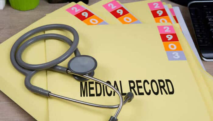 Stethoscope resting on medical record folders, highlighting the importance of medical evidence in tow truck company liability claims.