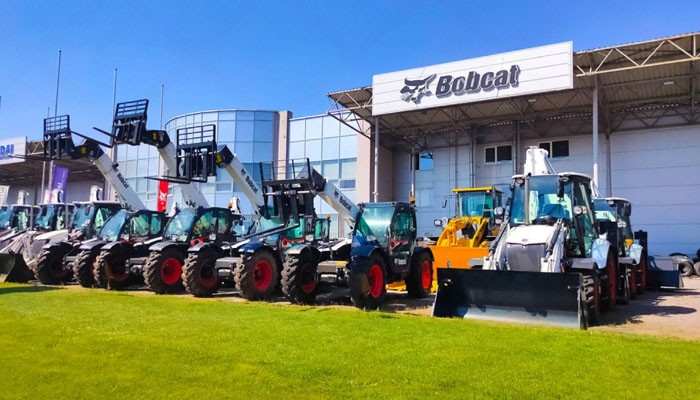 Bobcat loaders and compact equipment lined up outside a dealership, illustrating rental and buying options at bobcat of the rockies.