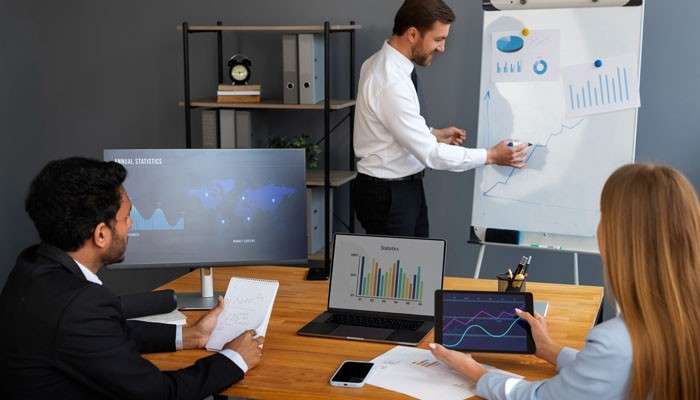 Why end-to-end ownership matters - tycoonstory | tycoonstory media Business process optimization team reviewing workflow charts, performance metrics, and process data to identify bottlenecks, improve end-to-end ownership, and increase operational efficiency.